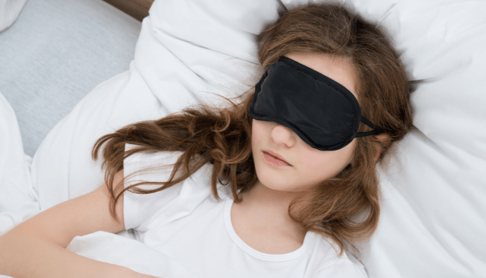 women sleeping wearing black sleep mask
